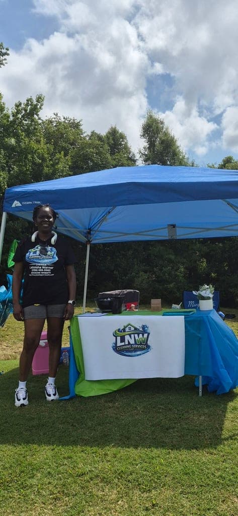 LNW Cleaning Services owner at a community event booth